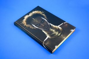 I AM IMAN is a book published by Booth-Clibborn Editions in 2001, with fantastic typography, gatefolds, diecuts, interactive elelments and frames commisioned and realized by Jonathan Barnbrook. It contains an introduction by David Bowie and photographs by Anna Leibowitz, Ellen Von Unwerth, Sante D'Orazio and Michel Comte among the others.